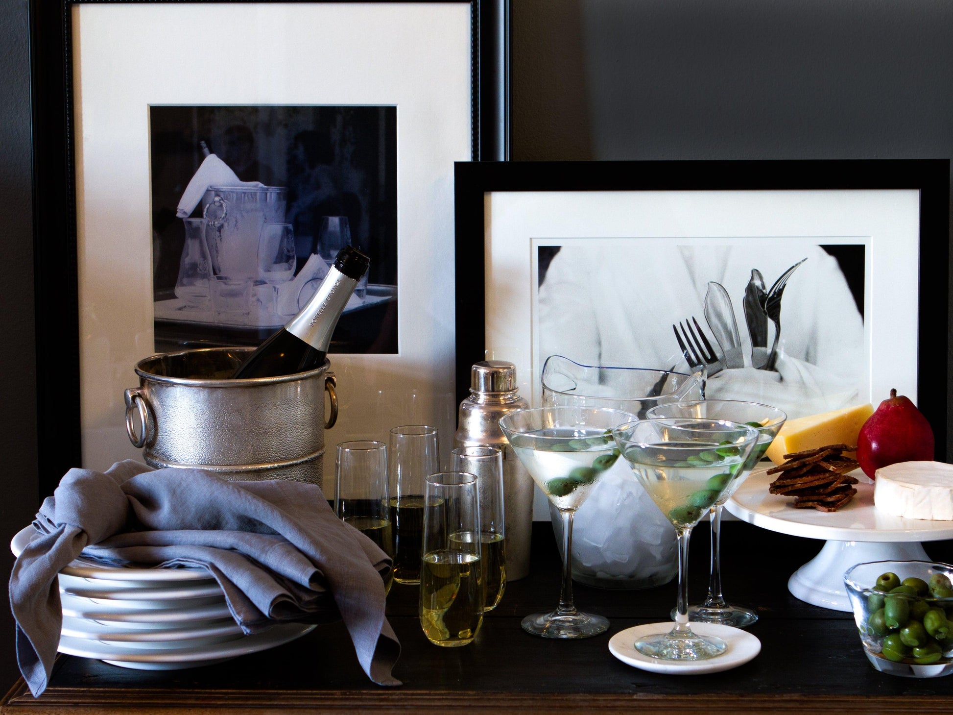 Large handblown glass ice bucket with handles, holding a champagne bottle.