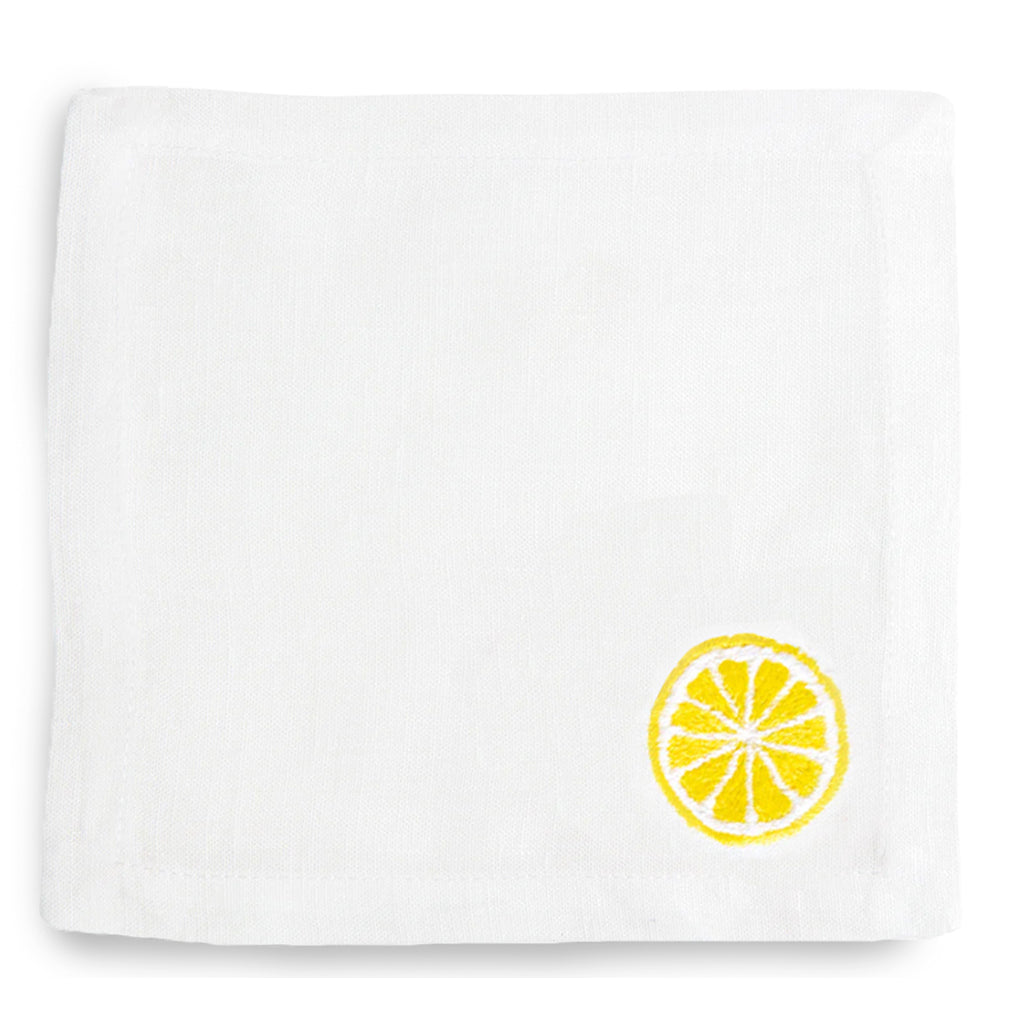 White linen cocktail napkin coaster with embroidered yellow lemon slice.