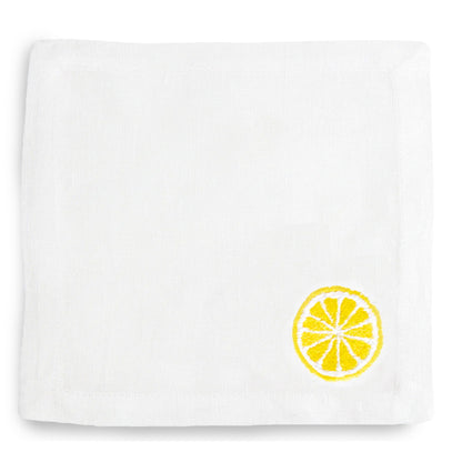 White linen cocktail napkin coaster with embroidered yellow lemon slice.