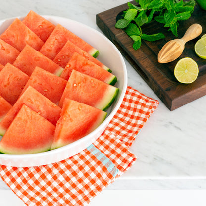 Luce Large Ceramic Serving Dish, white, round, filled with watermelon slices.