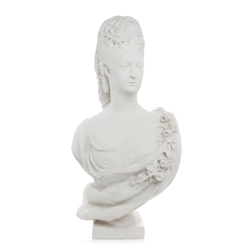 White resin bust of Marie Antoinette in period clothing with roses, on a square base.