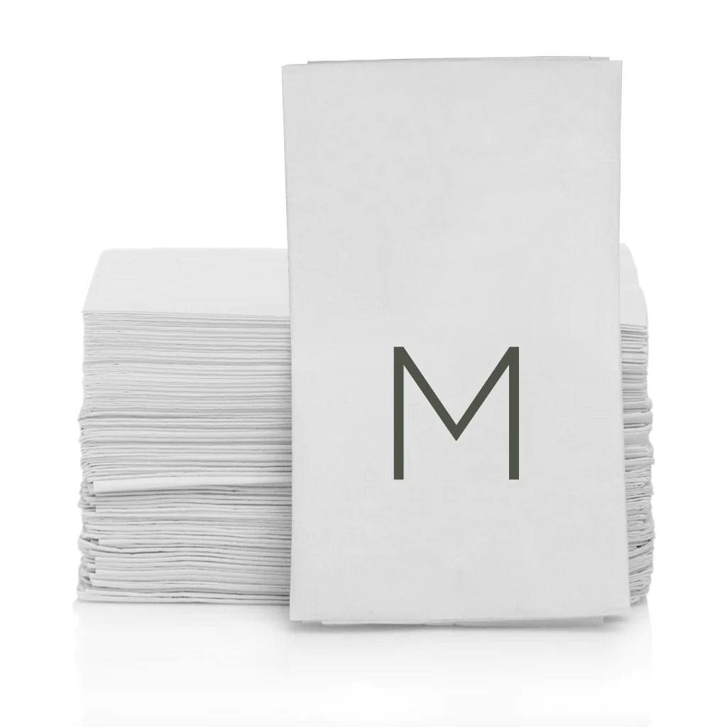 Stack of white 3-ply paper hand towels with a grey monogram "M" on the top towel.