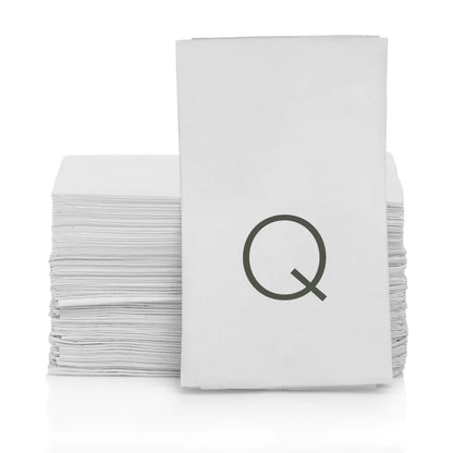 Stack of white 3-ply paper bar/hand towels with a grey monogram letter Q.