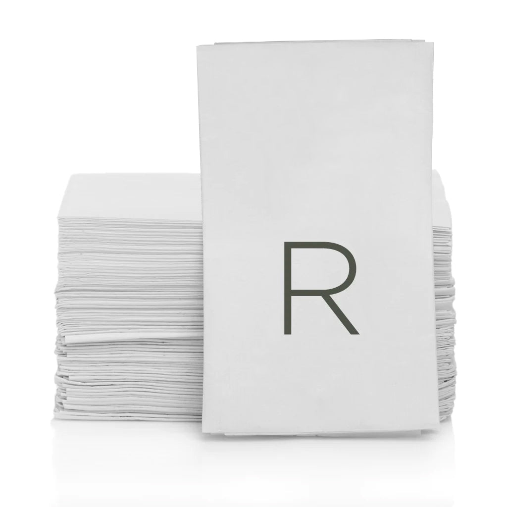 Stack of white 3-ply paper hand towels with a grey monogram "R" on the front.