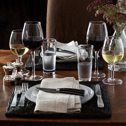 Mozes Scissor-Cut Water Glass, clear air-blown glass, 10.5 oz, on a set dining table.