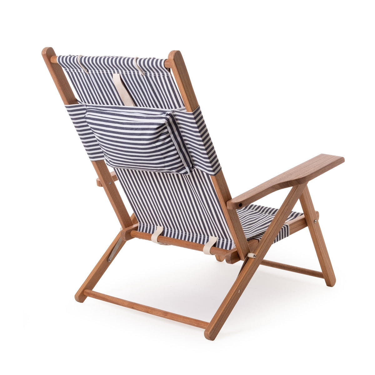 Navy and white stripe canvas reclining beach chair with wooden frame and back pocket.
