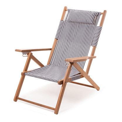 Navy and white stripe canvas reclining outdoor beach chair with a hardwood frame and padded headrest.