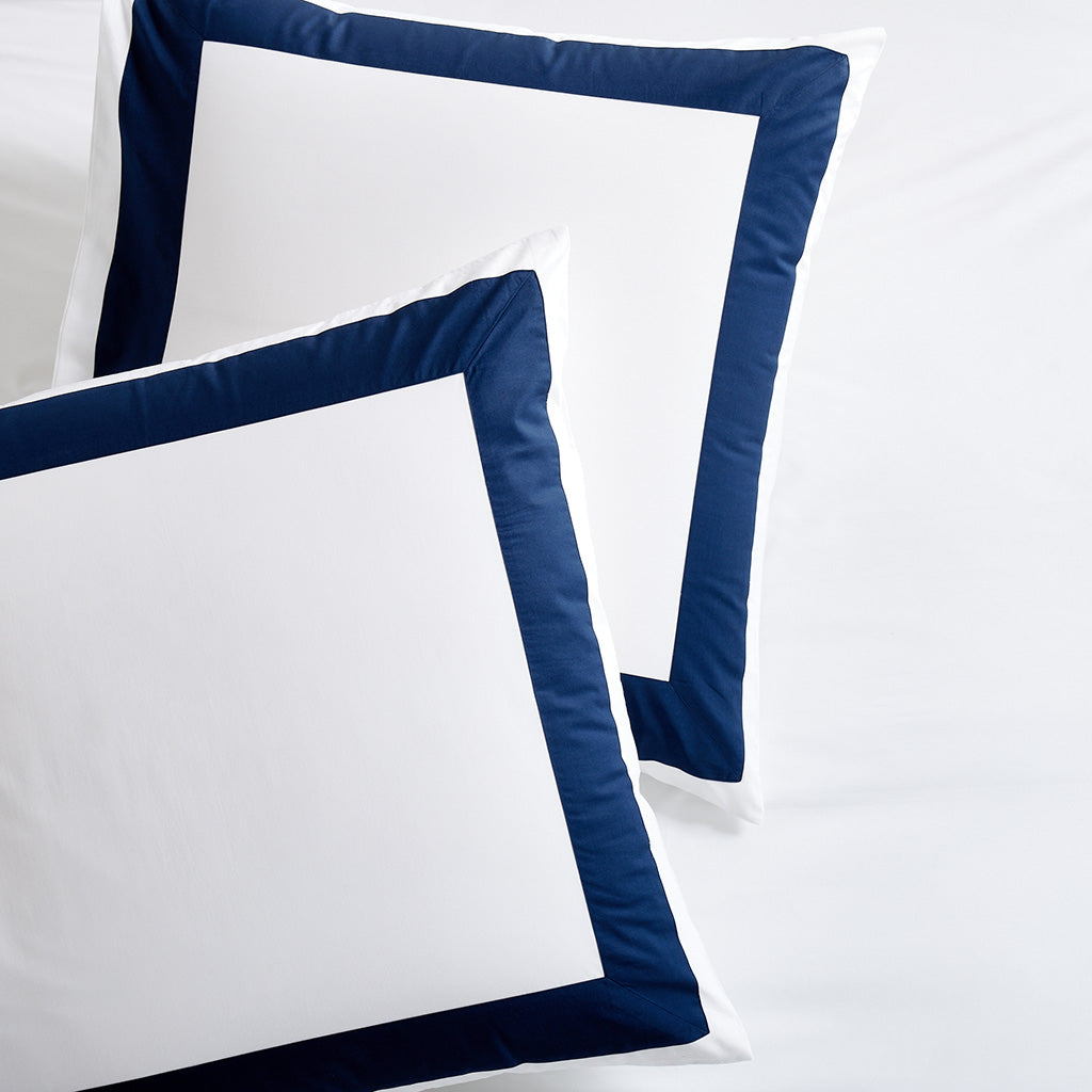 Set of 2 navy blue wide-band percale pillow shams with a crisp white center.