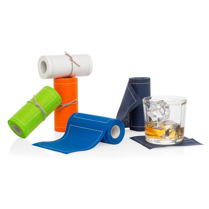 Orange tear-off cotton cocktail napkin roll with other colors, next to a drink on a coaster.