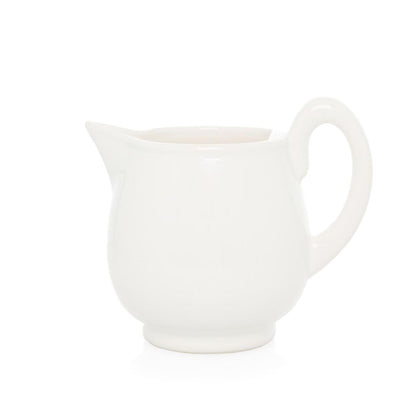 Creamy white ceramic pitcher with handle and angled spout.