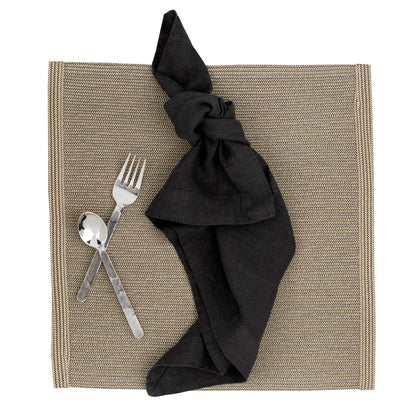 Orleans 5-piece stainless steel flatware set with hand-hammered texture, black napkin, and woven placemat.