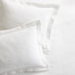 White cotton matelassé shams with subtle paisley pattern and tailored 2-inch hem.