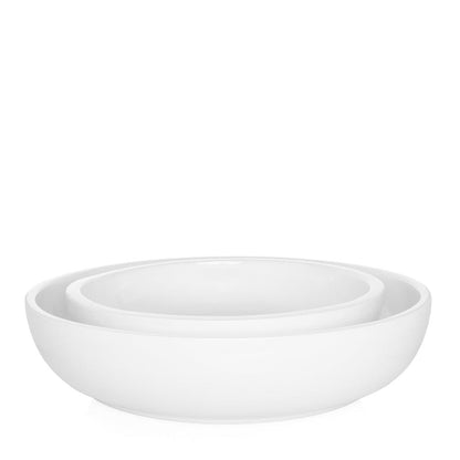 Two nested white ceramic serve bowls, Piatto Riso Large and smaller size, with sleek, simple design.