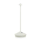 White die-cast aluminum Pina Pro rechargeable LED table lamp with a broad base and thin rod.