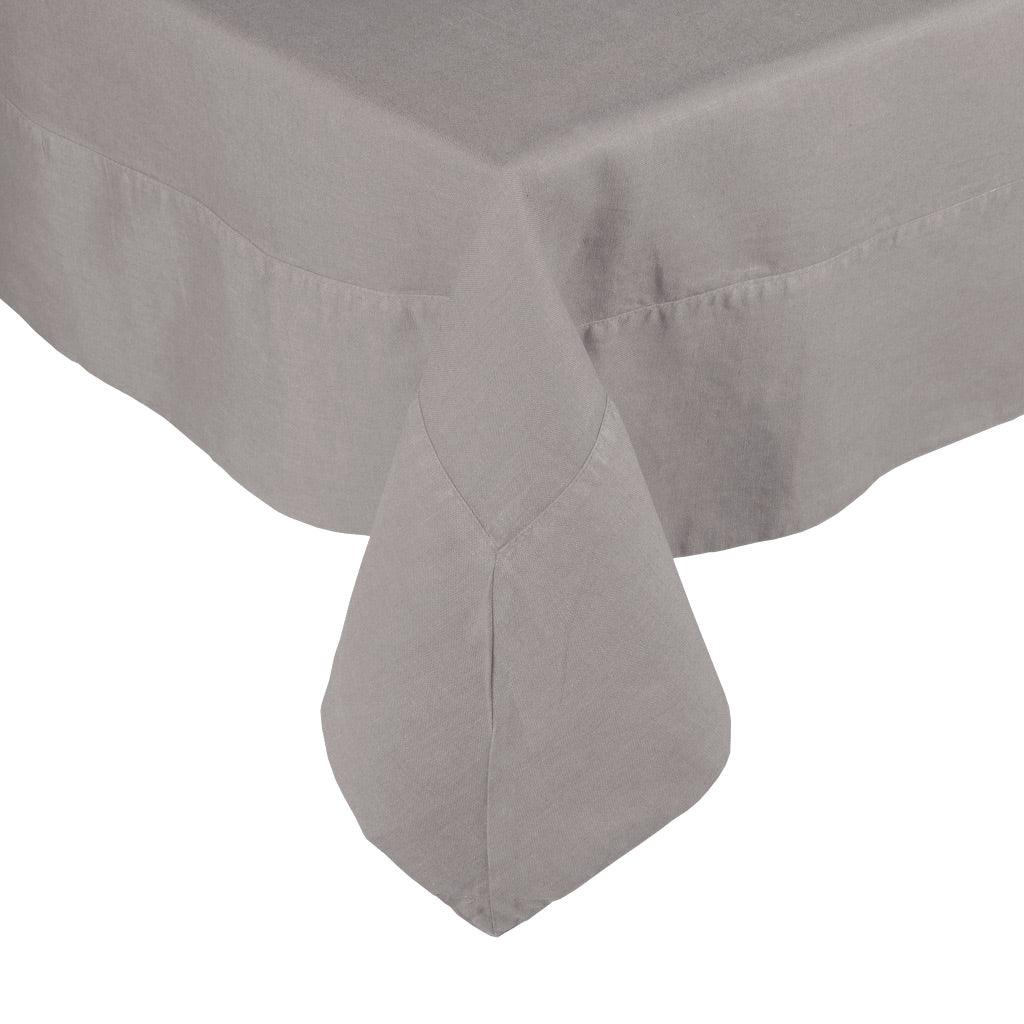 Rain HG Signature Hand-dyed Linen Tablecloth in a neutral grey, showing a mitered corner.