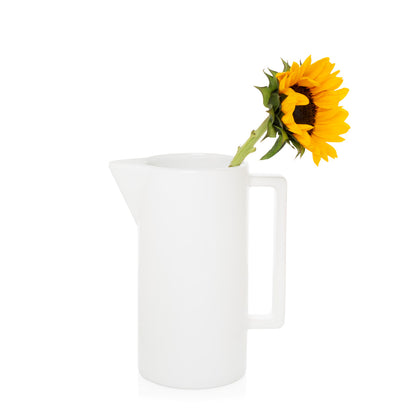 White ceramic rectangular handled pitcher with a single sunflower.