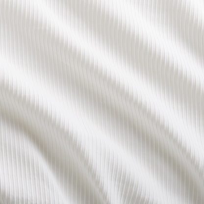 White ribbed cotton matelassé pillow sham with subtle texture and waves.