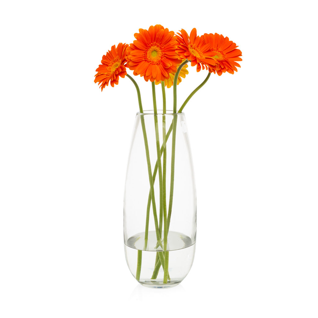 Robert Glass Vase, clear mouth-blown glass, 14.6"H, holding five orange gerbera daisies.