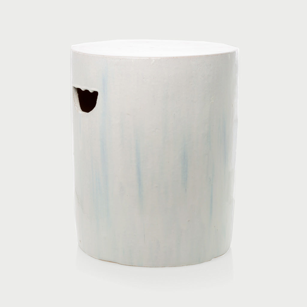 Rustic white ceramic cylinder garden stool with subtle blue streaks and a handle cutout.