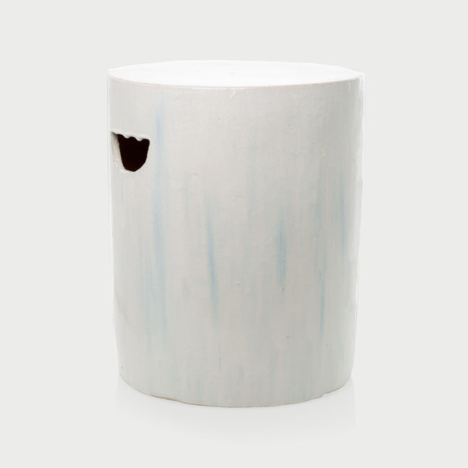 Rustic white ceramic cylinder garden stool with subtle blue streaks and a handle cutout.