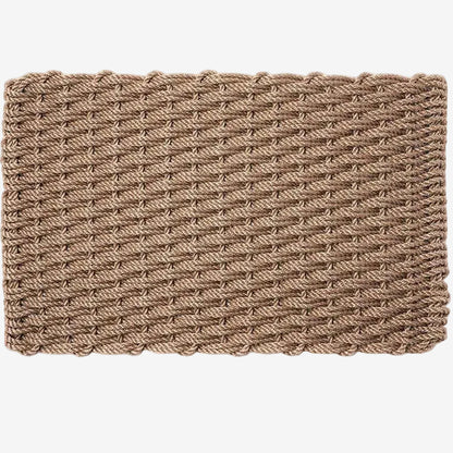Sand braided rope doormat, handwoven, rectangular, with a textured, tightly woven pattern.