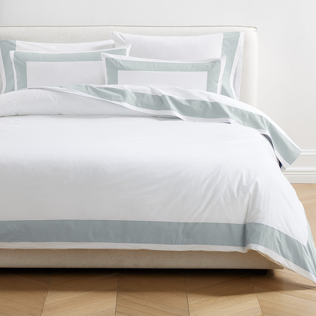 Seafoam Green Wide-Band Percale Pillow Shams, set of 2, on a bed with matching duvet cover.