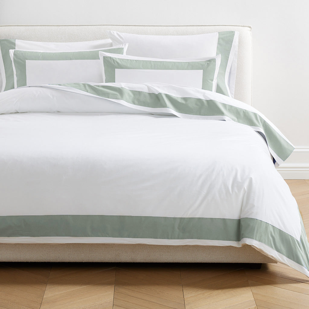 Seafoam green wide-band percale pillowcases and duvet cover set on a bed.