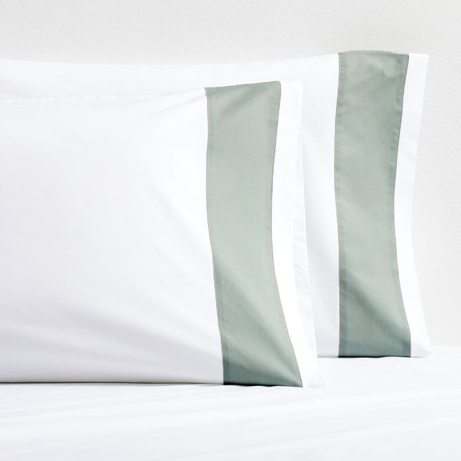 Set of two white percale pillowcases with a seafoam green wide-band detail.