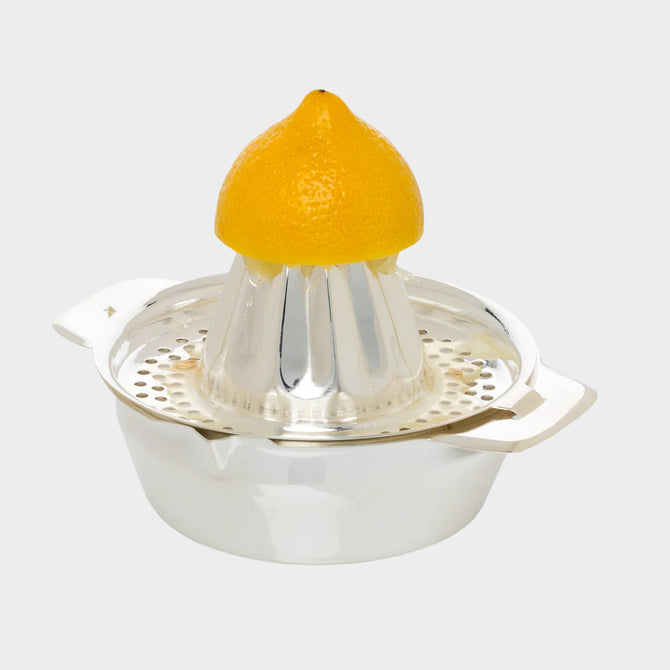 HG Silverplate Lemon Juicer, oversized, shiny silver, with a yellow lemon half on top.