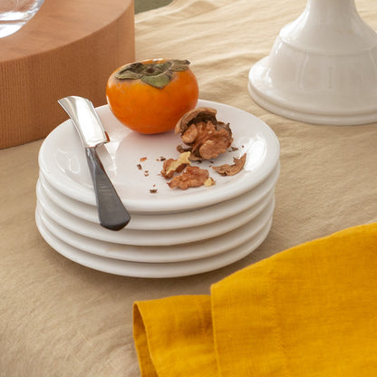 Stack of four white HG Appetizer earthenware small plates with a low lip, 6.5" diameter.