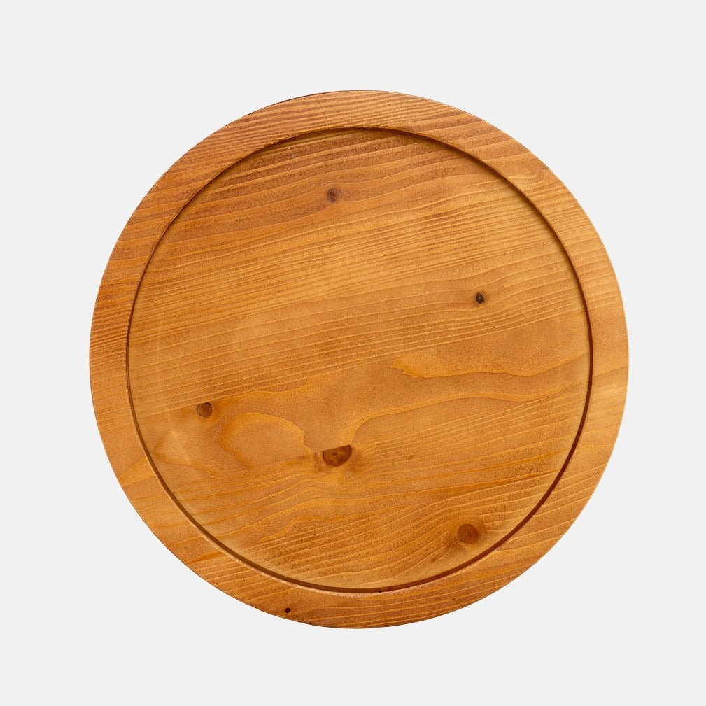 Small round natural reclaimed pine wood serving tray with raised rim and visible grain.