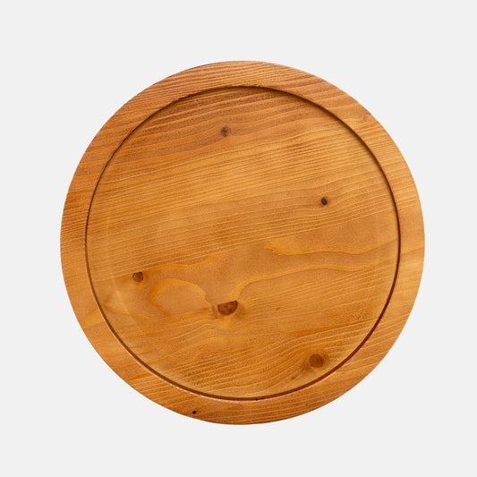 Small round natural reclaimed pine wood serving tray with raised rim and visible grain.