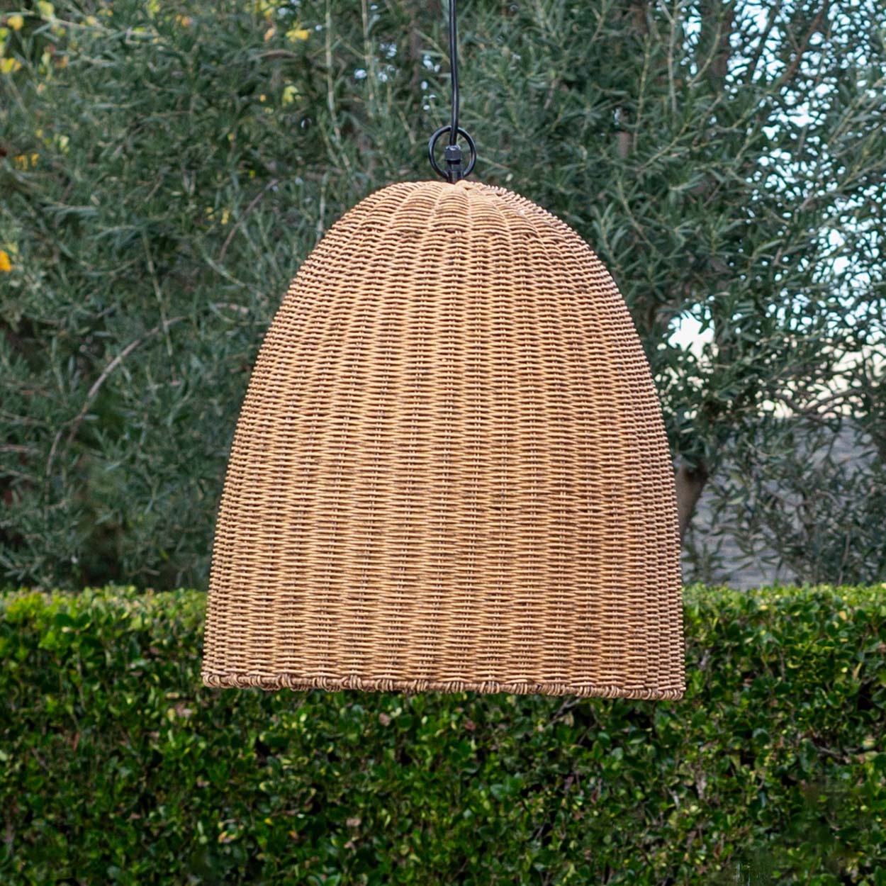 Small outdoor beehive pendant light with a dome-shaped, natural rattan-like woven shade.
