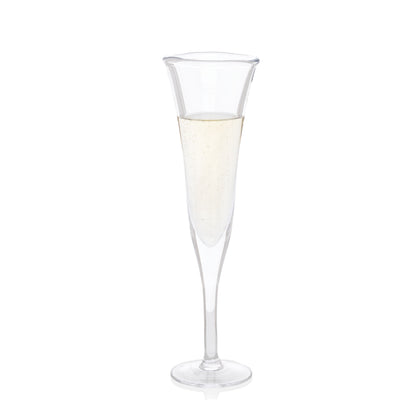 Clear, scissor-cut glass champagne flute with a rippled rim, filled with bubbly champagne.