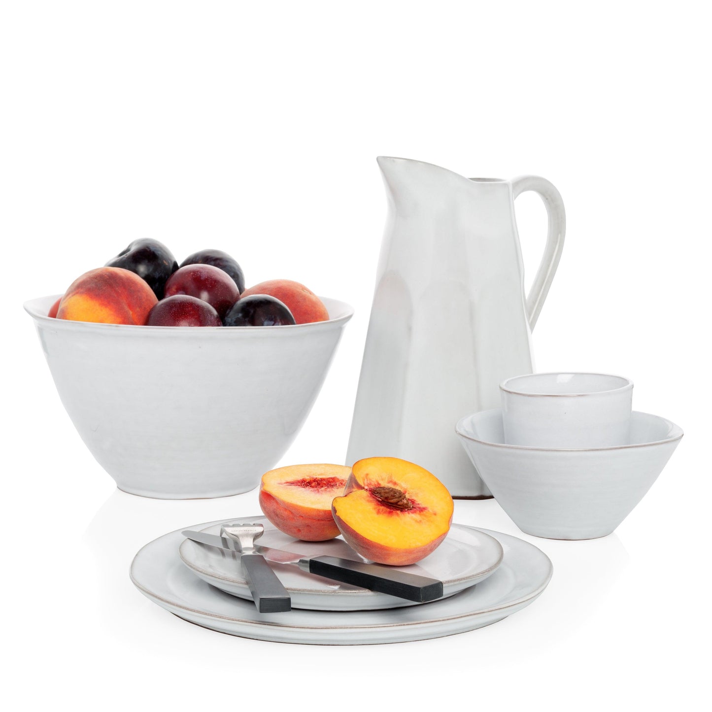 Stone Grey Stoneware Serve Bowl, 10.25" diameter, with fruit, pitcher, plates, and cup.
