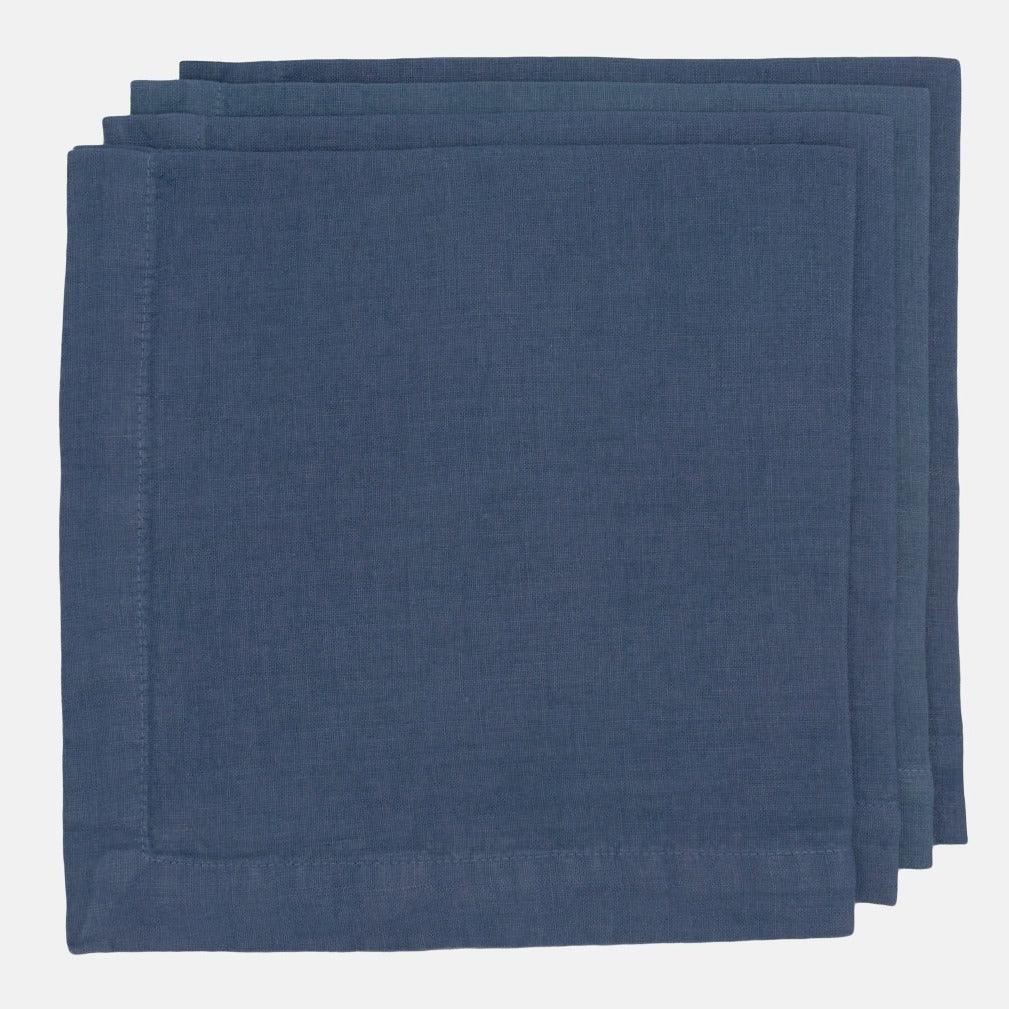 Stack of three Surf Blue HG Signature hand-dyed 22-inch linen napkins with mitered corners.