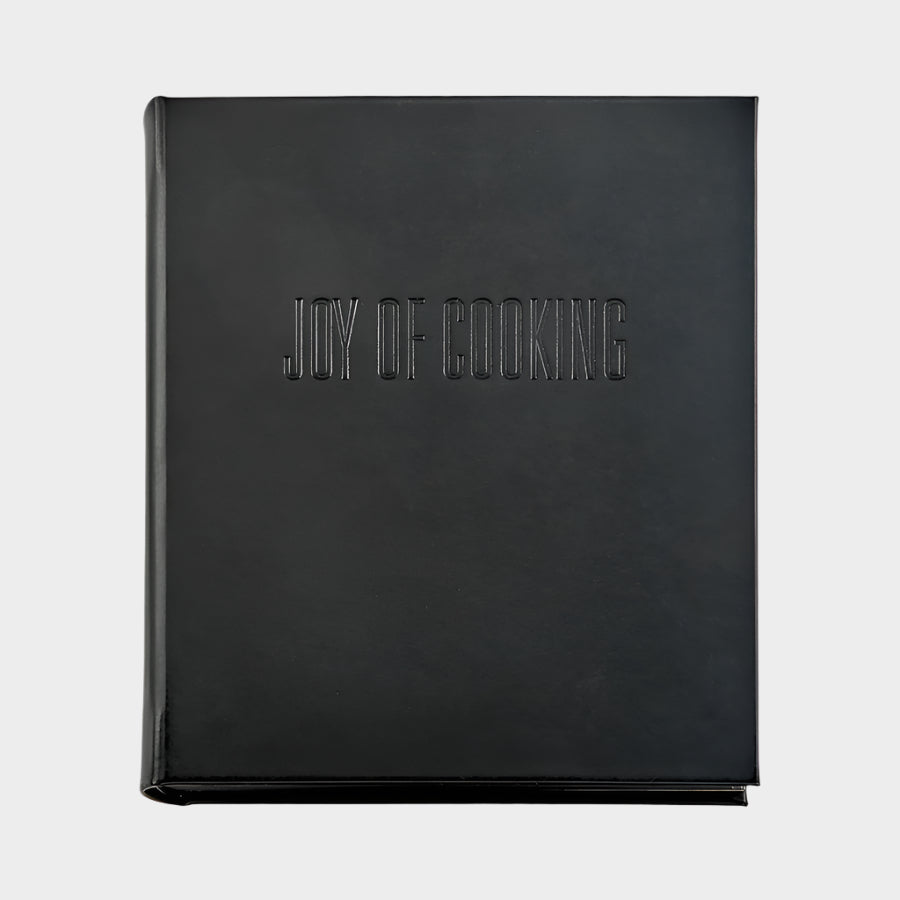 Black leather "Joy of Cooking" cookbook with blind embossed title.