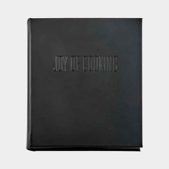 Black leather "Joy of Cooking" cookbook with blind embossed title.
