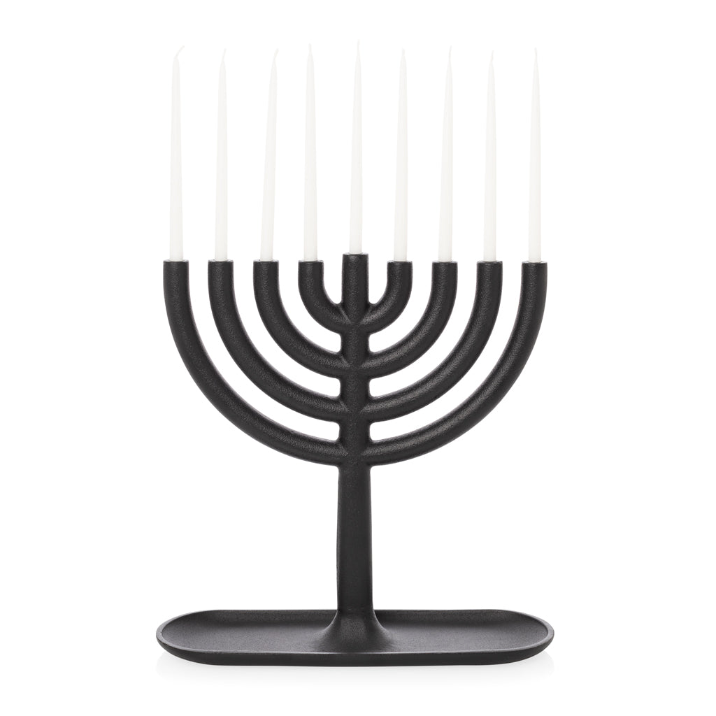 Black cast-iron Menorah with nine white, delicate, elongated taper candles.