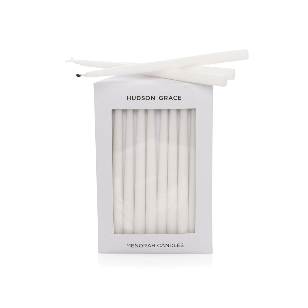 Hudson Grace white paraffin Menorah candles, delicate elongated tapers, in a white box with window.