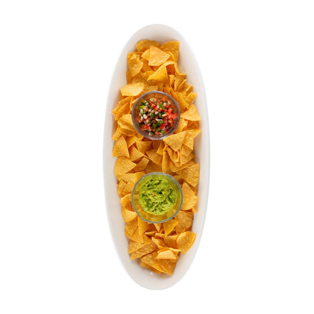 Torino Large Oval Ceramic Serving Platter, white, filled with tortilla chips, guacamole, and salsa.