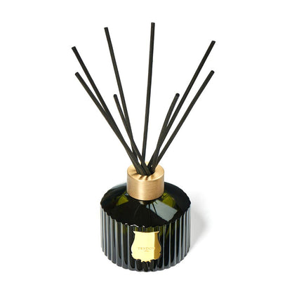 Trudon Ernesto Scented Reed Diffuser: 11-oz fluted dark green glass with gold seal, brass top, and black rattan sticks.