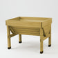 VegTrug Classic Wood Planter, a light brown cedarwood raised bed with four legs and a slatted base.