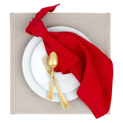 Vintage Oro gold 5-piece flatware set on white plates with a red napkin and beige placemat.
