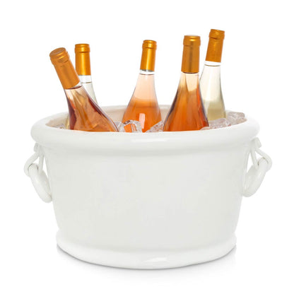 White ceramic oval ice bucket with ring handles, holding four bottles of wine and ice.