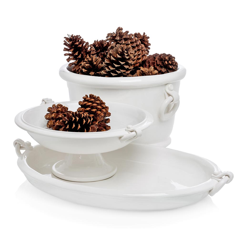 White ceramic oval ice bucket with ring handles, shown with matching pedestal bowl and tray.