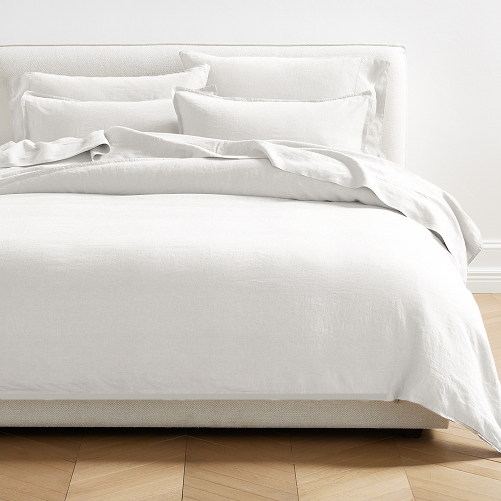 White Washed-Linen Duvet Cover with matching shams on a bed, showcasing the relaxed texture.