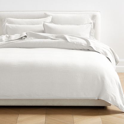 White Washed-Linen Duvet Cover with matching shams on a bed, showcasing the relaxed texture.