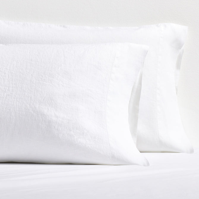 Set of two white washed-linen pillowcases with double-needle stitch detailing and side opening.