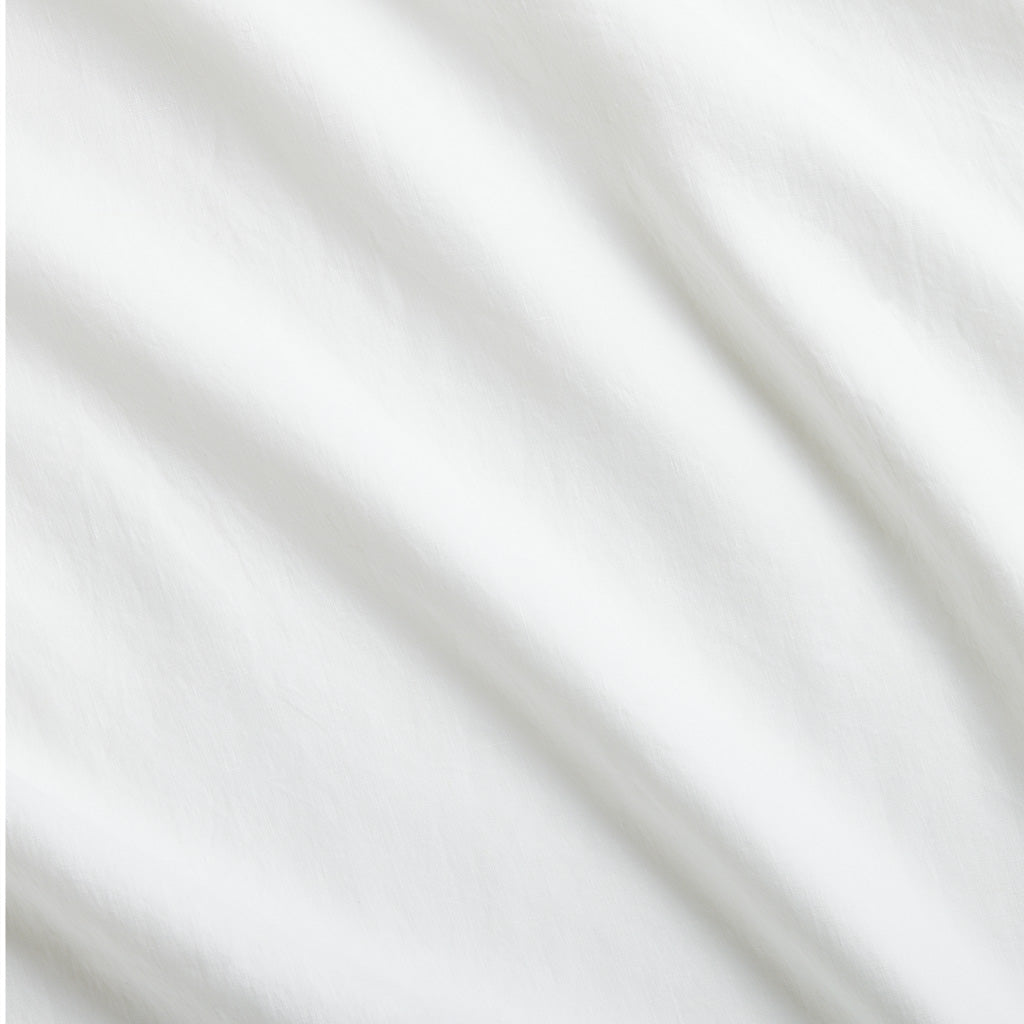 White Washed Linen Sheet Set with soft, casually relaxed fabric folds.